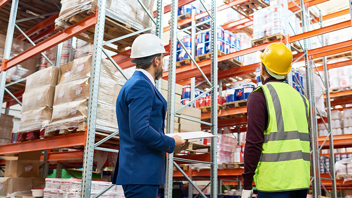 Warehouse staff and management in conversation