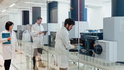 Scientists in a laboratory working with biopharmaceutical equipment, illustrating regulatory frameworks for single-use systems.